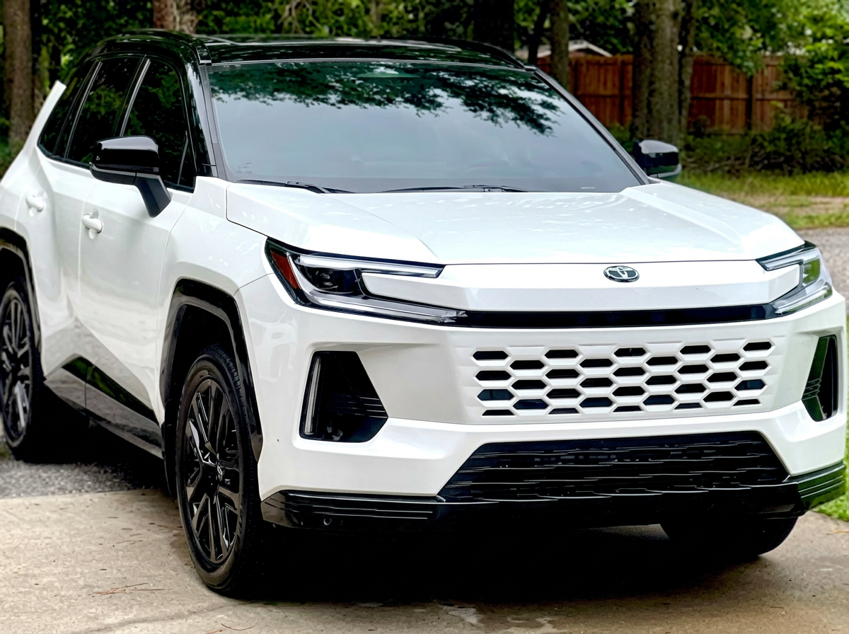 White SUV with dark tinted windows parked on a driveway